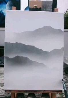 an easel with a painting on it in the process of being painted by someone