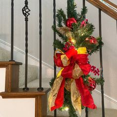 a decorated christmas tree sitting on top of a banister