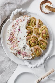 a white plate topped with lots of food next to other plates and utensils