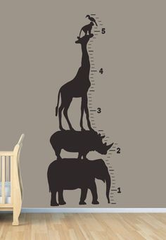 a giraffe and two rhinos are on the growth chart wall decal