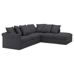 a gray sectional couch with pillows on it