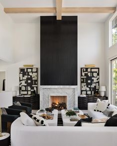 a living room filled with furniture and a fire place in the middle of a room