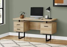 a computer desk with two drawers and a monitor