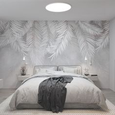 a bedroom with white walls and palm leaves on the wall, along with a large bed