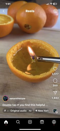 an orange is being used to light a candle