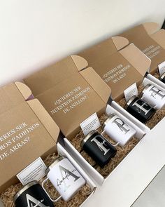 five different types of coffee mugs sitting in a box on top of a table