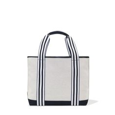 a white and black striped tote bag on a white background with the handles down