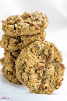 three oatmeal cookies stacked on top of each other in front of a white background