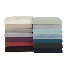 a stack of sheets with different colors and sizes on top of each other, all folded up