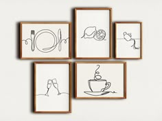 four framed drawings on the wall above a coffee cup