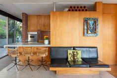 a living room filled with furniture next to a kitchen