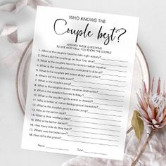 a couple's best question card sitting on top of a plate next to a flower