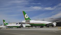 two airplanes are parked on the tarmac at an airport