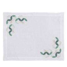 a white place mat with green leaves on it