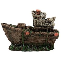 a small boat made out of wood and moss on the bottom is an orange flower