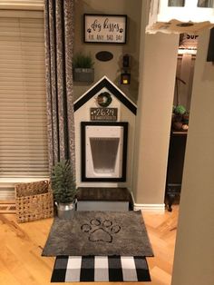 a dog house made out of cardboard with a cat's paw on the door