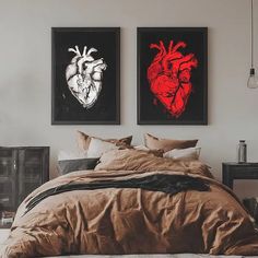 two paintings on the wall above a bed in a room with a brown comforter