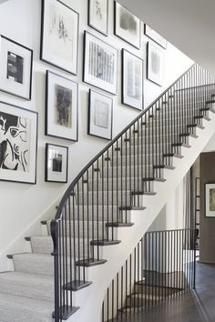 there is a staircase with pictures on the wall