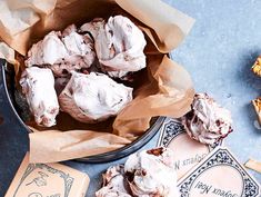 a bowl filled with cookies next to some other items on a table and paper bags