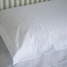 a white pillow with lace trim on it