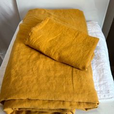 two yellow blankets folded on top of each other