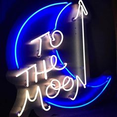 a neon sign with the words to the moon written in white and blue letters on it