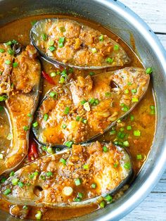 an image of some food that is in the pan on the table with it's spoon