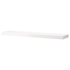 a white shelf sitting on top of a wall