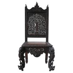 an ornate wooden chair with carvings on the back