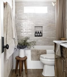 a white toilet sitting next to a bath tub