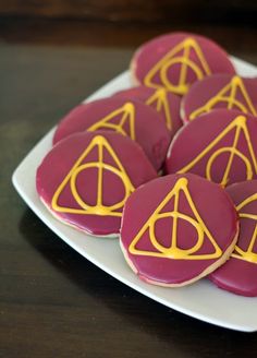 harry potter cookies on a plate with yellow icing