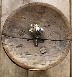 an old wooden clock with flowers on it