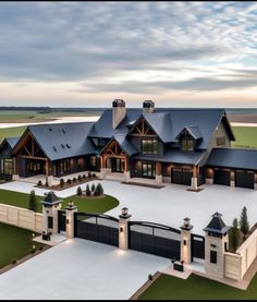 an aerial view of a large house with lots of windows on the front and side