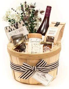 a basket filled with wine, cheese and other items