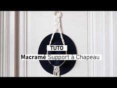 a clock hanging from the side of a white door with text reading tuto macrame support a chapeau