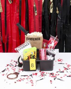 a table topped with lots of red and black confetti