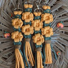 four tassels are attached to the handles of some kind of bag or purse