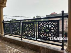 a balcony with wrought iron railings and pillars