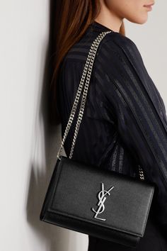 SAINT LAURENT's 'Kate' bag has been made in Italy from durable textured-leather that's punctuated with the label's iconic 'YSL' logo plaque. This compact style is sized to fit all the essentials and has a sliding chain strap that can either be worn on your shoulder or cross-body - tuck it away to carry yours as a clutch.    Wear it with: [SAINT LAURENT Shirt id1265074], [SAINT LAURENT Pants id1109779], [SAINT LAURENT Sandals id1265616]. Ysl Kate Bag Outfit, Ysl Clutch, Saint Laurent Shirt, Bag Suitcase