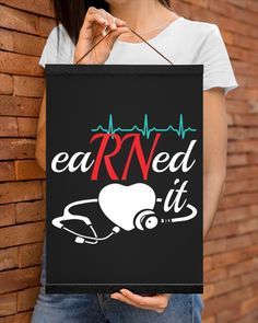 a woman holding up a sign that says eat rnd it with a stethoscope