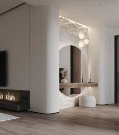 a living room with white walls and wood flooring has a fireplace in the center