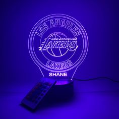 the los angeles lakers basketball team logo is shown on a purple background with a remote control