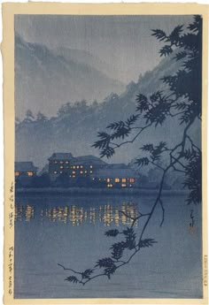 an image of a lake with buildings in the background and trees on the shore at night