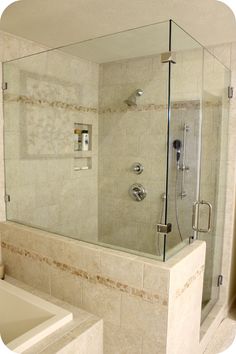 a bath tub sitting next to a walk in shower