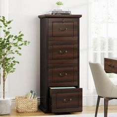 a tall wooden cabinet next to a white chair and potted plant in a room