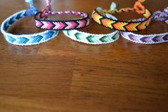 three bracelets sitting on top of a wooden table