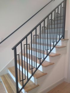 a set of stairs with wooden treads in a house