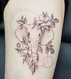 an elephant with flowers on it's head is shown in this tattoo style photo