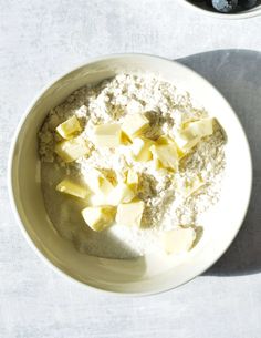 a white bowl filled with food on top of a table