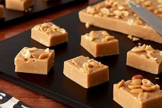 several pieces of peanut butter fudge on a black tray